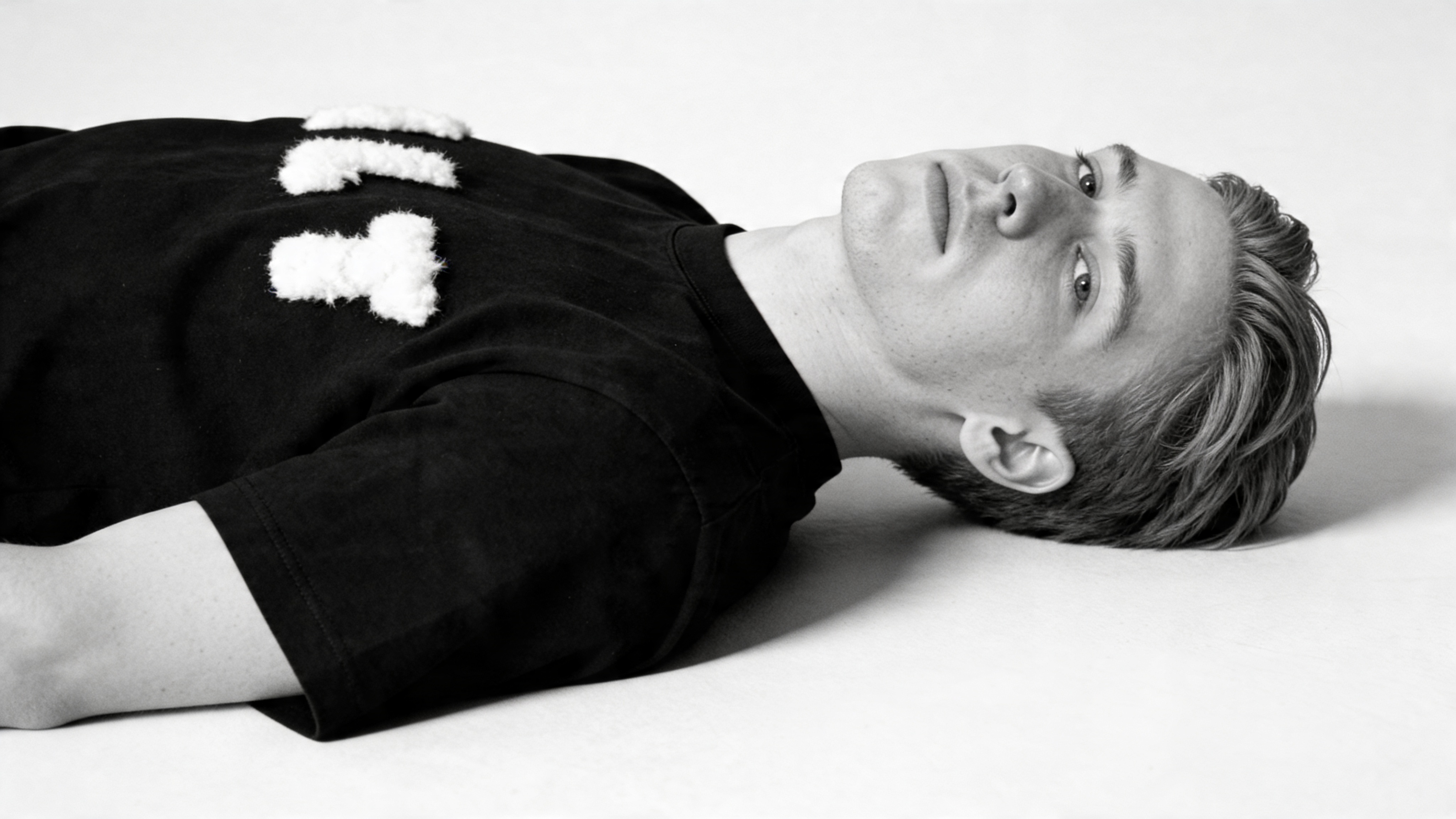 HLT444 look in black shirt, reclining portrait